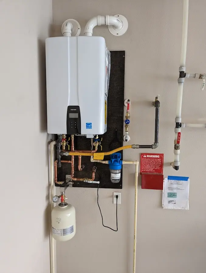 Professional plumber installing copper piping in a Davenport home